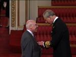 Image: Councillor Baxter collects his MBE